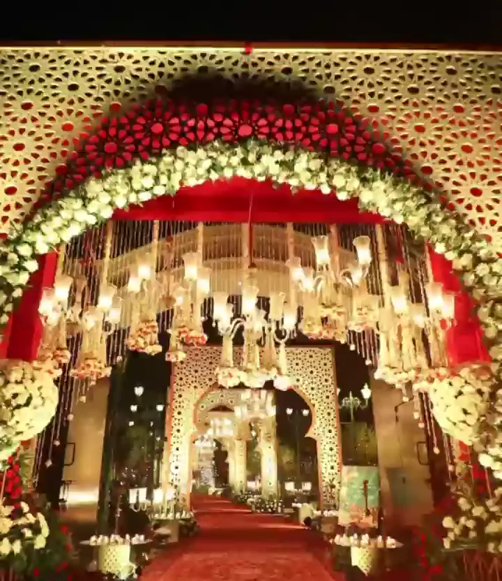 Carved arched entrance with white flowers and red lining
