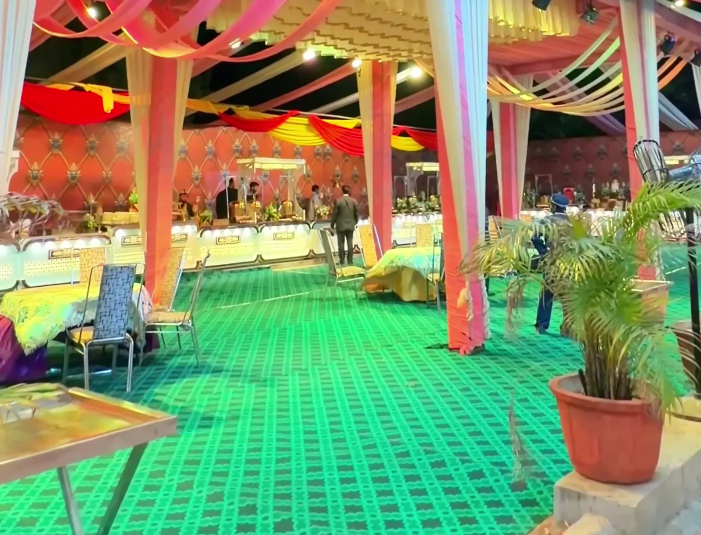 Large dining hall with seating laid out under draped fabric