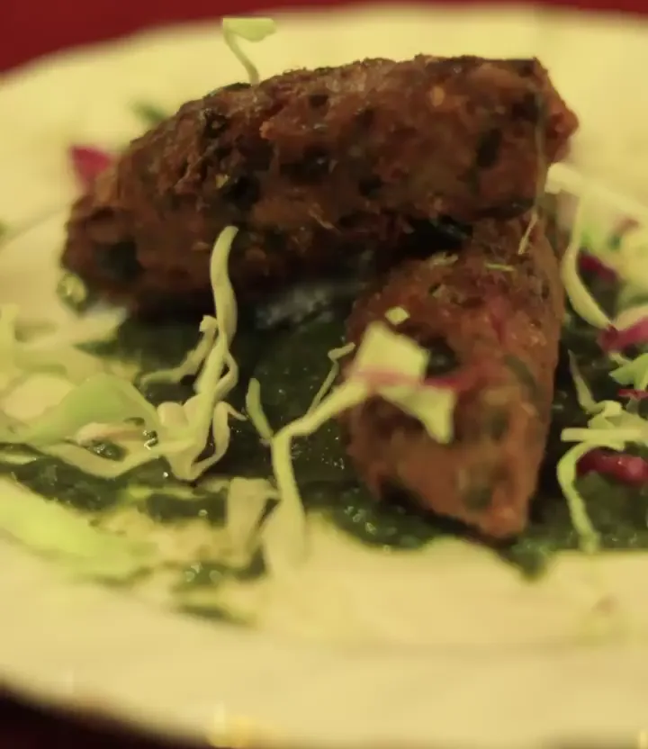 Plate of kebabs served with shredded salad