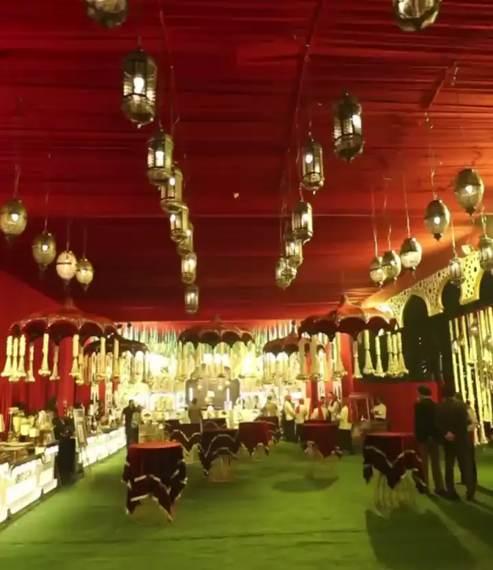 Dining hall hung with lanterns under red drapes