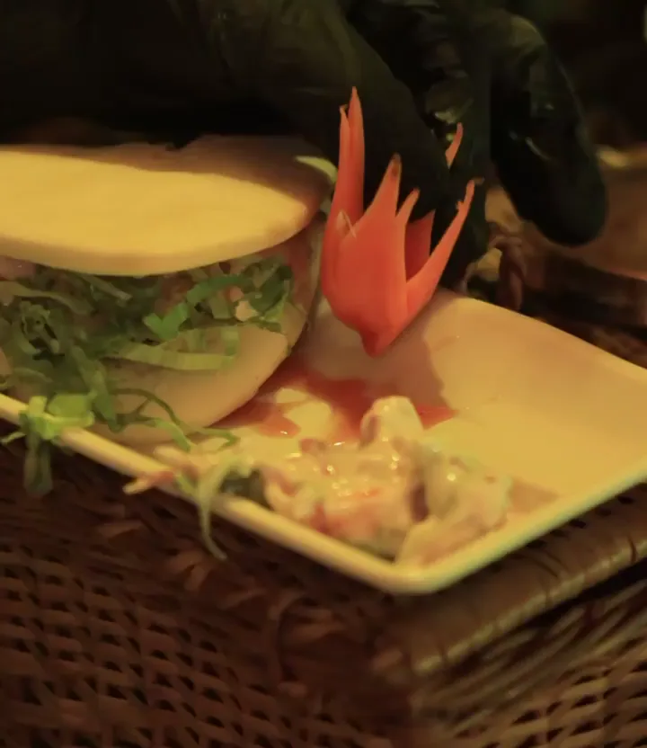 Plated snack on a wicker tray with a carved garnish
