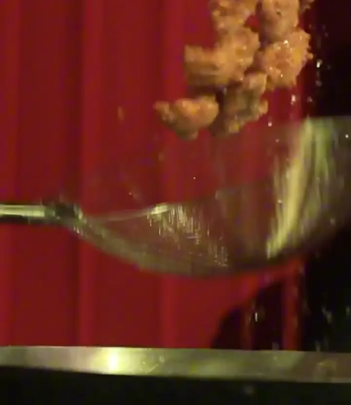 Spoon lifting food from a serving dish