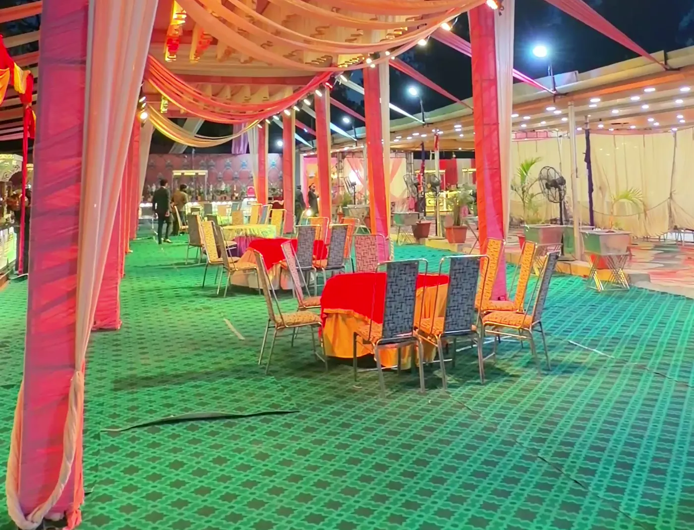 Tented dining area with tables and drapes